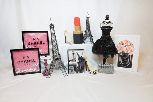 Paris themed party decorations including 2 Eiffel towers, chanel no. 5 signs, images, and a bodice shaped centerpiece
